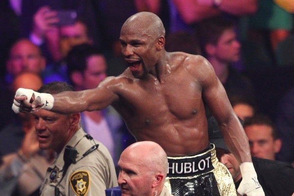 Floyd Mayweather Jr. points into the stands after his unanimous decision over Manny Pacquiao in their welterweight title unification fight May 2 at the MGM Grand Garden. Mayweather raised his reco ...
