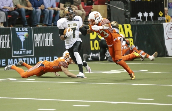 Las Vegas Outlaws, Ray Little (7) pushes away Spokane Shocks player Jeff Richards (23), as he runs the ball up the field from a kick off return during a football game between the Las Vegas Outlaws ...