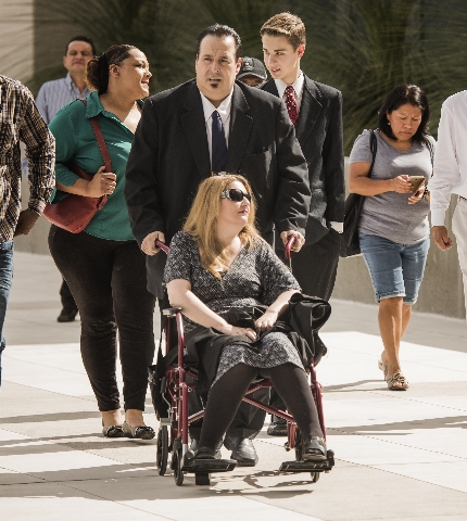 Leon Benzer, left, pushes  his ex-wife Karen in a wheelchair at  Lloyd D. George U.S. Courthouse Thursday, Aug. 6, 2015  before his sentencing. Benzer, the mastermind of the scheme to take over an ...