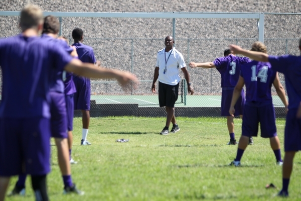 Former UNLV and NFL star Randall Cunningham, Silverado High School‘s football coach, watches his players Monday during stretches. (Erik Verduzco/Las Vegas Review-Journal)