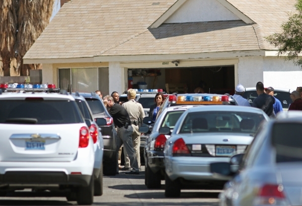 Police respond to an officer-involved shooting in the 6900 block of Berkshire Place on Friday, Aug. 7, 2015, in Las Vegas. Police checking reports of a broken window shot and killed a man who lung ...