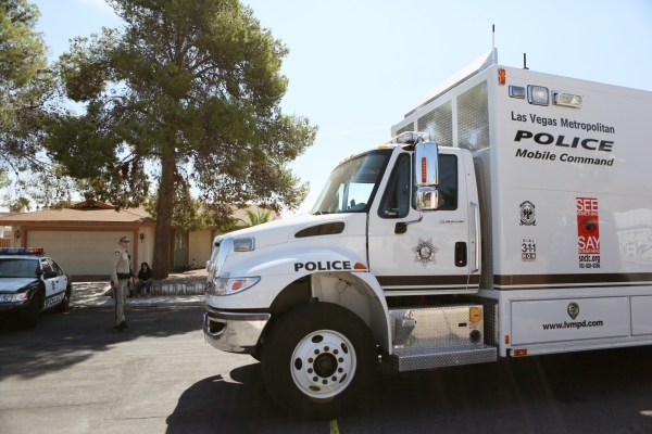 Las Vegas Metropolitan Police Mobile Command responds to an officer-involved shooting in the 6900 block of Berkshire Place Friday, Aug. 7, 2015, in Las Vegas. Police checking reports of a broken w ...