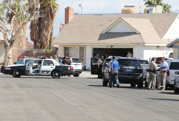 Las Vegas police investigate an officer-involved shooting in the southwest valley in the 6900 block of Berkshire Place, near the intersection of Rainbow Boulevard and Tropicana on Friday, Aug. 7,  ...