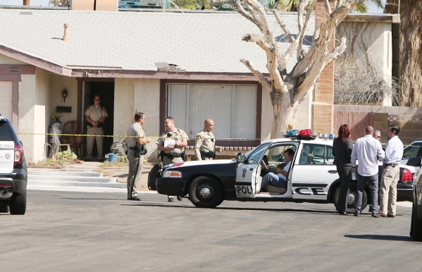 Las Vegas police investigate an officer-involved shooting in the southwest valley in the 6900 block of Berkshire Place, near the intersection of Rainbow Boulevard and Tropicana on Friday, Aug. 7,  ...