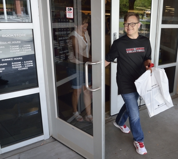 Clayton Rhodes leaves the UNLV bookstore recently with his mother, Shelley. He is preparing for a new school year. (Bill Hughes/Las Vegas Review-Journal)