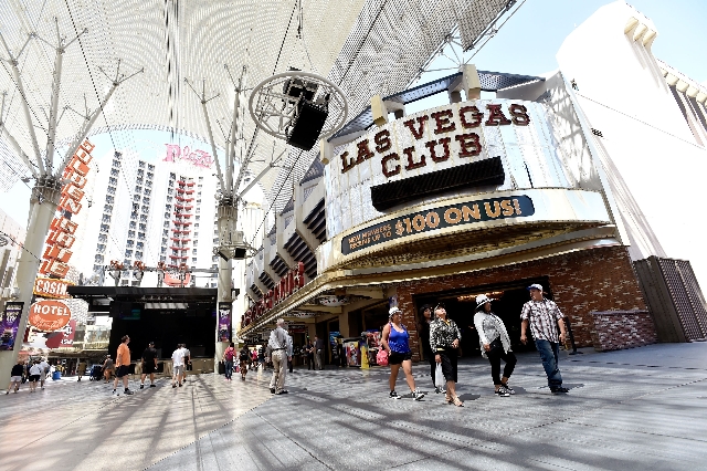 Tourists walk along the Fremont Street Experience in front of the Las Vegas Club hotel-casino on Monday, Aug. 17, 2015, in Las Vegas. The 86-year-old sports-themed downtown property was recently s ...