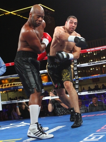 Trevor Bryan, left, takes a hard right from Derric Rossy during their NABF heavyweight title fight at the Downtown Las Vegas Events Center in Las Vegas on Friday, Aug. 28, 2015. Chase Stevens/Las  ...