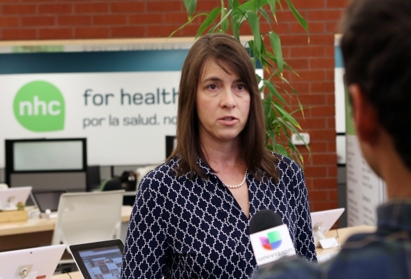 The Nevada Health CO-OP member and Board Director, Stacey Hatfield, left, addresses the media at the co-op‘s walk-in center on 3900 Meadows Ln. Wednesday, Aug. 26, 2015. A nonprofit insurer  ...