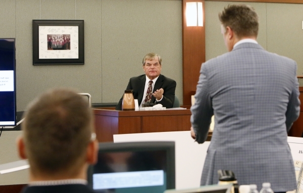 Dr. Albert Capanna, center, speaks during cross examination at his trial as Beau Orth, left, and his Attorney Dennis Prince, right, look on at the Regional Justice Center in Las Vegas Friday, Aug. ...