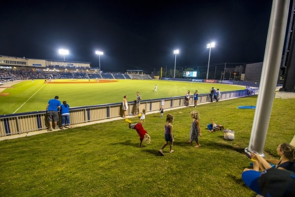 Kids play in a grass area behind the outfield while the Biloxi Shuckers take on the Pensacola Blue Wahoos at MGM Park in Biloxi, Miss. on Wednesday, Aug. 12, 2015. (Joshua Dahl/Las Vegas Review-Jo ...