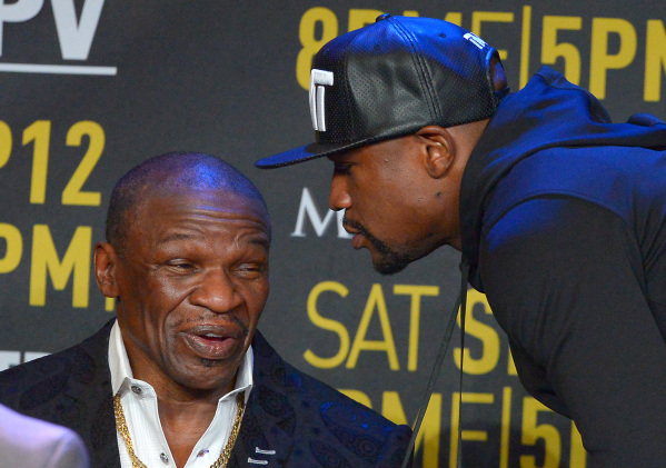 Welterweight champion Floyd Mayweather Jr., right, speaks to his father Floyd Mayweather Sr. on Thursday in Los Angeles at a news conference to promote Floyd Jr.‘s fight against Andre Berto  ...