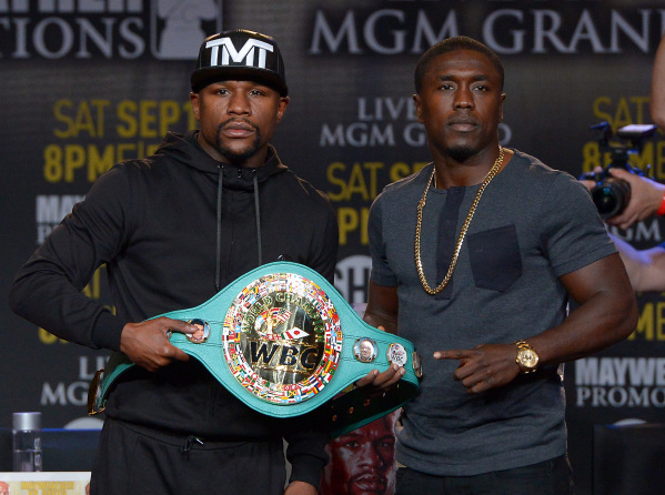 Undefeated champion Floyd Mayweather Jr., left, allows Andre Berto to touch the welterweight belt that will be at stake during their Sept. 12 fight at the MGM Grand Garden. The fighters were in Lo ...