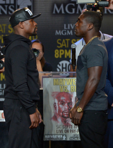 Undefeated champion Floyd Mayweather Jr., left, faces off with Andre Berto on Thursday in Los Angeles where the welterweights began promotion for their Sept. 12 title fight at the MGM Grand Garden ...
