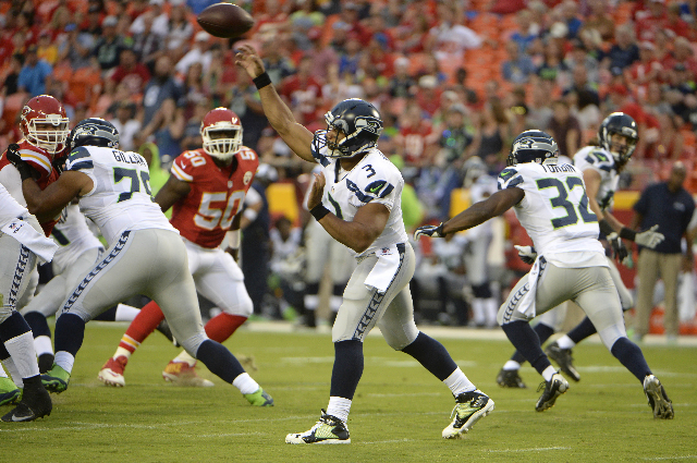 Aug 21, 2015; Kansas City, MO, USA; Seattle Seahawks quarterback Russell Wilson (3) throws a pass against the Kansas City Chiefs in the first half at Arrowhead Stadium. (John Rieger/USA Today Sports)