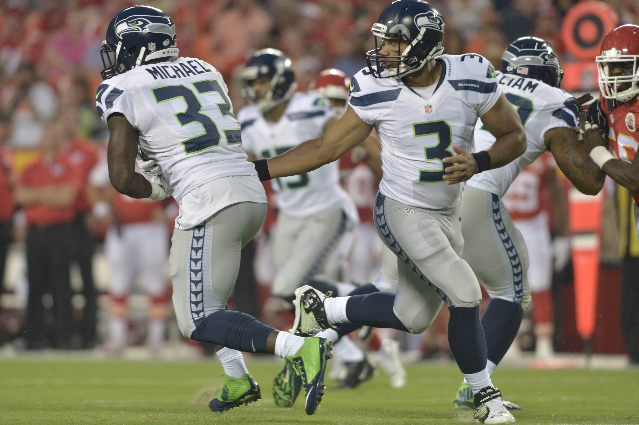 Aug 21, 2015; Kansas City, MO, USA; Seattle Seahawks quarterback Russell Wilson (3) hands off to running back Christine Michael (33) during the first half at Arrowhead Stadium. (Denny Medley/USA T ...