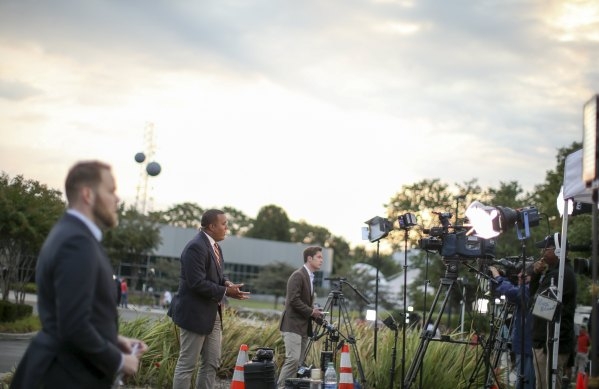 Television journalists conduct on-site morning broadcasts on Thursday outside the offices of a Roanoke, Va., station, where slain journalists Alison Parker and Adam Ward worked. Chris Keane/Reuters