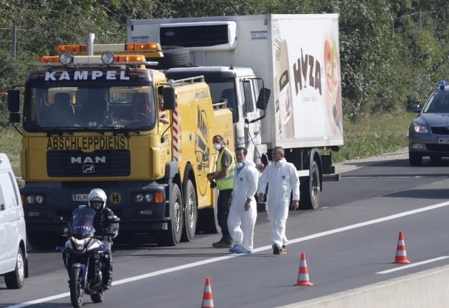 A truck in which migrants were found dead, is prepared to be towed away on a motorway near Parndorf, Austria August 27, 2015.  REUTERS/Heinz-Peter Bader