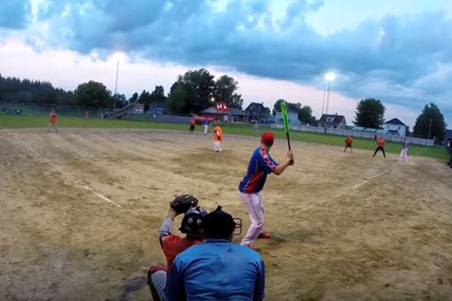 Softball player belts mind-blowing backwards home run - VIDEO.