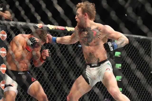 Conor McGregor, right, looks to throw a jab at Chad Mendes during their interim featherweight title bout at UFC 189 at the MGM Grand Garden Arena Saturday, July 11, 2015, in Las Vegas. McGregor wo ...