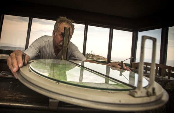 Bureau of Land Management fire outlook employee John Dubovick uses the fire distance map at the  Ella Mountain fire watchtower on Wednesday, Aug. 19, 2015. JEFF SCHEID/LAS VEGAS REVIEW-JOURNAL