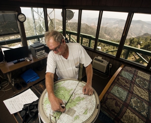 Bureau of Land Management fire outlook employee John Dubovick uses the fire distance map at the  Ella Mountain fire watchtower on Wednesday, Aug. 19, 2015. JEFF SCHEID/LAS VEGAS REVIEW-JOURNAL Fol ...