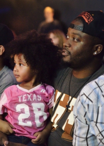 LJ Johnson, right, and his daughter Keilani watch the action on stage during His Hop, a youth program at Family Worship Christian Church at 3945 E. Patrick Lane in Las Vegas on Friday, Aug. 14, 20 ...