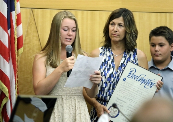Golfer Morgan Goldstein, left, speaks during a Clark County Commission meeting after behing honored at the Clark County Commission chambers Aug. 18. Morgan‘s mother Karri, center, and brothe ...