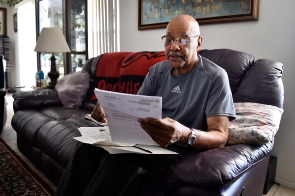 Retired Air Force veteran Willie Smith reviews his VA paperwork during an interview at his North Las Vegas home on Monday, Aug. 31, 2015. (David Becker/Las Vegas Review-Journal)