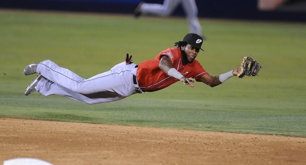 El Paso Chihuahuas shortstop Hector Gomez makes a diving catch to rob Las Vegas 51s‘ Dilson Herrera of a base hit in the third inning of their Triple-A minor league baseball game at Cashman ...