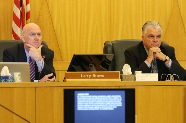 Commissioner Larry Brown, left, and Commissioner Steve Sisolak, chairman, listen to public comment during a public hearing for More Cops sales tax at of a County Commission meeting at the commissi ...
