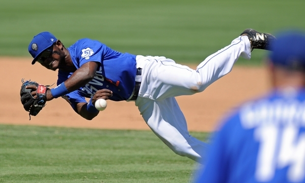 Las Vegas 51s second baseman Dilson Herrera makes a diving throw to first baseman Brooks Conrad while on the run to force out a Tacoma Rainiers batter in the fifth inning at Cashman Field in Las V ...