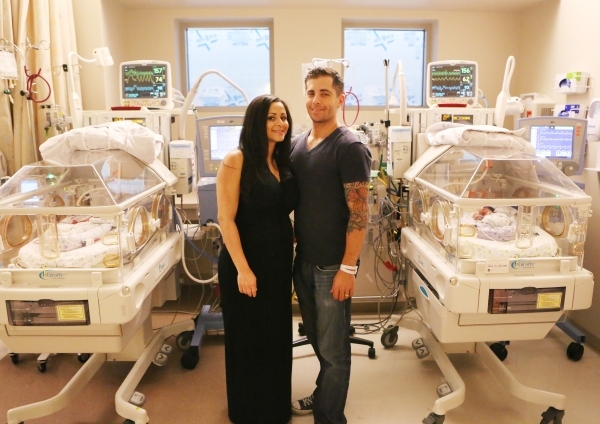 Silvia Farra and her husband Douglas II pose for a photo between their premature twin boys, Dougie, left, and Donnie, right, who were placed inside an incubator at Spring Valley Hospital on Thursd ...