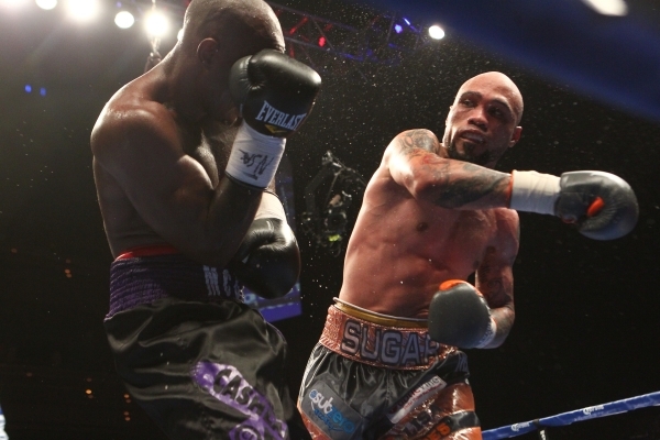 Ishe Smith, right, delivers a punch to Cecil McCalla during their junior middleweight fight at The Pearl at the Palms on Thursday, April 30, 2015. Ishe Smith won the fight by unanimous decision. ( ...