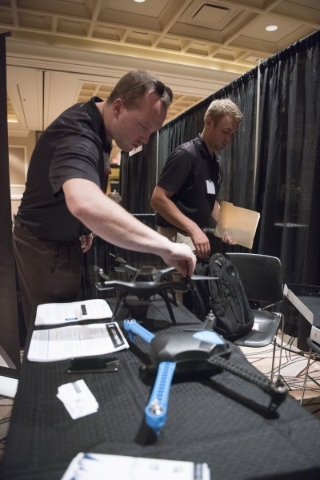 Nevada Dynamics employees CEO MacCallister Higgins, left, and President Erik Edgington set up their Reno-based start-up‘s display at InterDrone in the convention center at the Rio hotel-casi ...