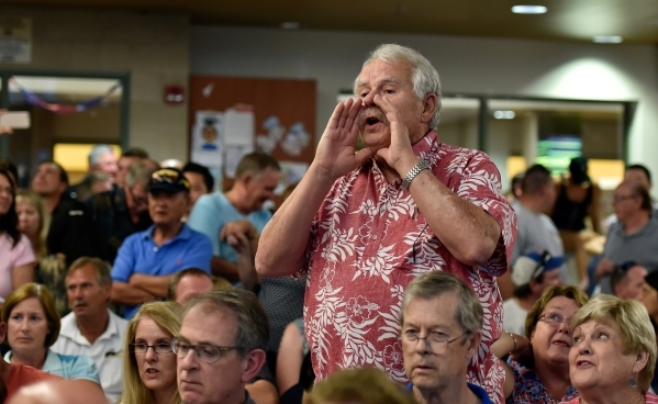 Resident Dwight Magness speaks at a homeowners association meeting for the Silverstone golf course community at the Centennial Hills YMCA in Las Vegas on Tuesday, Sept. 8, 2015. A crowd of several ...