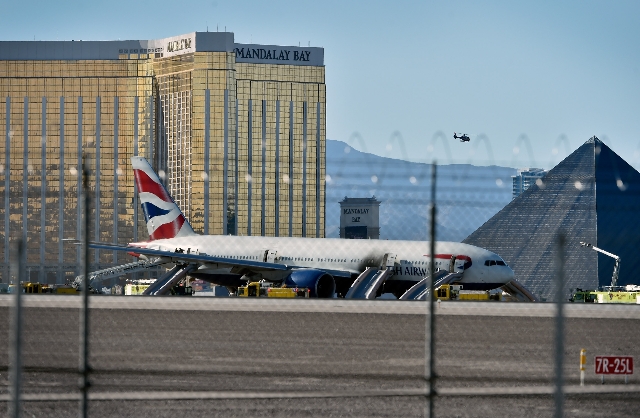A British Airways passenger jet is park on the runways after a fire at McCarran International Airport on Tuesday, Sept. 8, 2015. The Boeing 777-200 was headed to Gatwick Airport in London on fligh ...