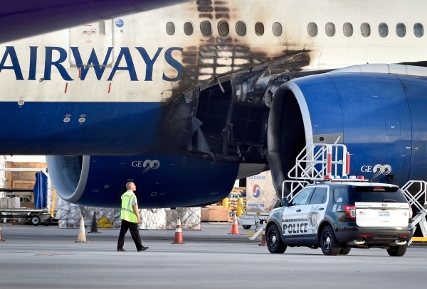A damaged British Airways Boeing 777-200 is parked at McCarran International Airport on Wednesday, Sept. 9, 2015, in Las Vegas. An engine caught fire before takeoff Tuesday forcing the evacuation  ...