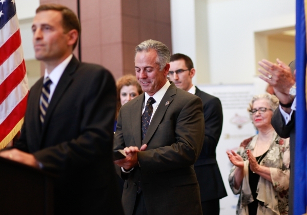 Sheriff Joe Lombardo, center, claps as Nevada Attorney General Adam Laxalt, left, announces funding for testing a three-decade backlog of rape kits, at the Sawyer Building in Las Vegas Thursday, S ...