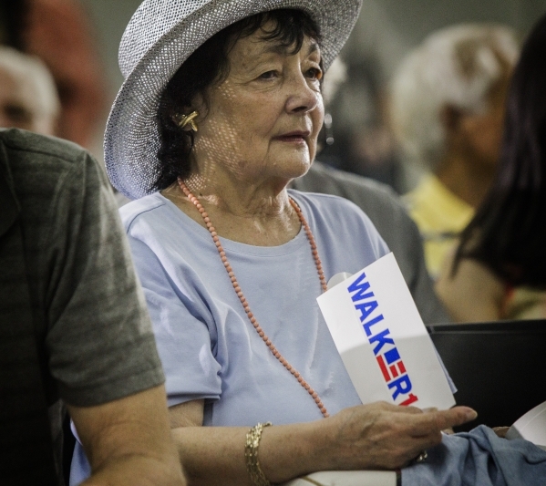 Florence Nardino uses a bumper sticker to fan herself during a town hall meeting with Republican presidential candidate Wisconsin Gov. Scott Walker  at XTreme Manufacturing Warehouse,1415 West Bon ...