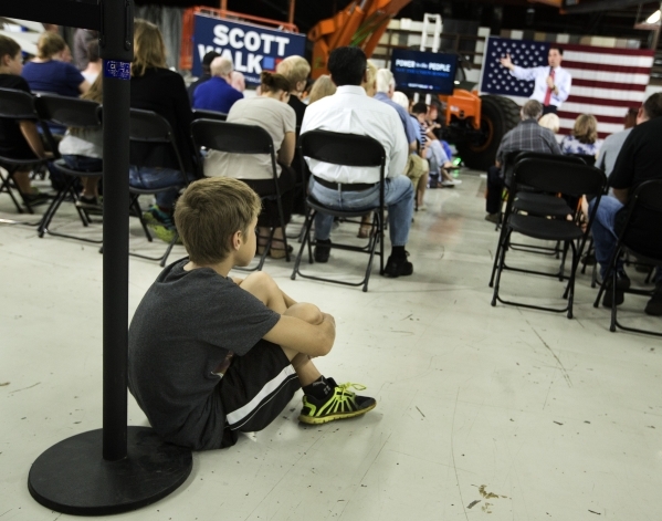 Aiden Sewart, 10. listens while Republican presidential candidate Wisconsin Gov. Scott Walker speaks during a town hall at XTreme Manufacturing Warehouse,1415 West Bonanza Road, on Monday, Sept. 1 ...