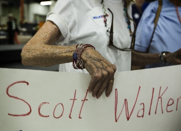 Gaye McDonald holds a sign during a town hall meeting with Republican presidential candidate Wisconsin Gov. Scott Walker at XTreme Manufacturing Warehouse,1415 West Bonanza Road, on Monday, Sept.  ...