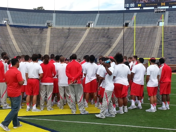 UNLV players gather around coach Tony Sanchez at "The Big House" on Friday in  Ann Arbor, Mich. Mark Anderson/Las Vegas Review-Journal