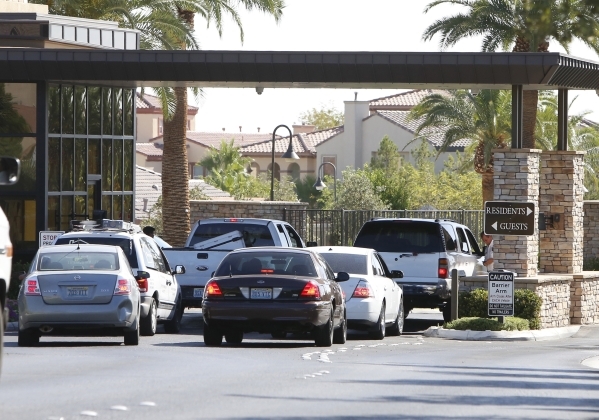 Guests enter the Rhodes Ranch Golf Club while Las Vegas police investigate a shooting that left one person wounded and one arrested at the 100 block of Crooked Putter Drive Monday, Sept. 14, 2015. ...