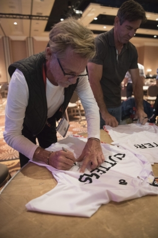 Dennis Christopher, left, and Dennis Quaid sign Cutters team jerseys from the movie "Breaking Away" during a cast reunion at Interbike at Mandalay Bay Convention Center in Las Vegas Thur ...