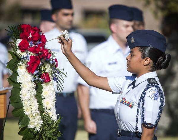 Air Force Junior ROTC cadet Vanessa Cruz places a flower on a wreath during  National POW/MIA Recognition Day at Freedom Park at Nellis Air Force Base on Friday, Sept. 18,2015. JEFF SCHEID/LAS VEG ...