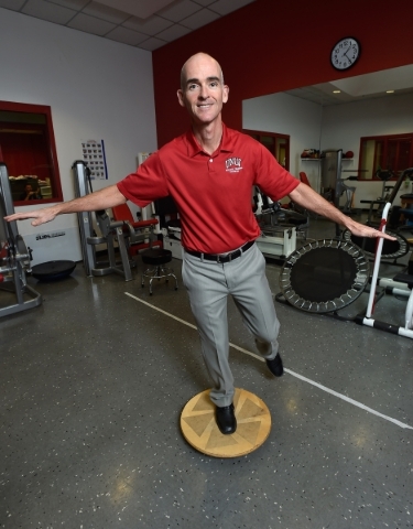 Tedd Girouard, UNLV‘s director of athletic training, uses a balancing device as he poses at UNLV on Monday, Sept. 21, 2015. Balance is a key determination when testing for determining a poss ...