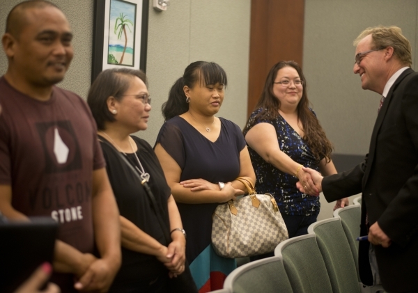 From left, Tony Paet, Carmelita Paet, Carmela Paet, and Jaqueline Blas celebrate with prosecuting attorney Frank Coumou at the Regional Justice Center in downtown Las Vegas on Friday, Sept. 25, 20 ...