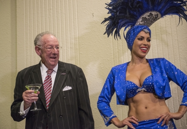 Former Las Vegas Mayor and current Las Vegas Convention and Visitors Authority spokesperson Oscar Goodman and showgirl Jennifer Johnson speak during a reunion of the survivors of the USS Bismarck  ...