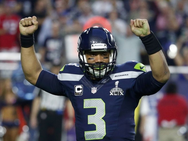 Seattle Seahawks quarterback Russell Wilson celebrates his touchdown pass to  wide receiver Chris Matthews (not pictured)  in the final seconds of the first half against the New England Patriots d ...