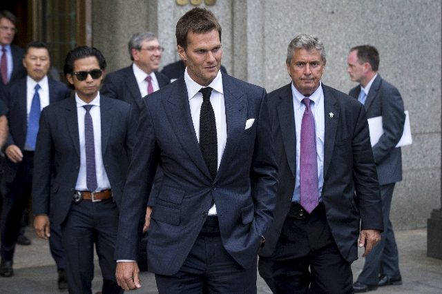 New England Patriots quarterback Tom Brady exits the Manhattan Federal Courthouse in New York August 12, 2015. A federal judge on Wednesday fired tough questions at a National Football League lawy ...